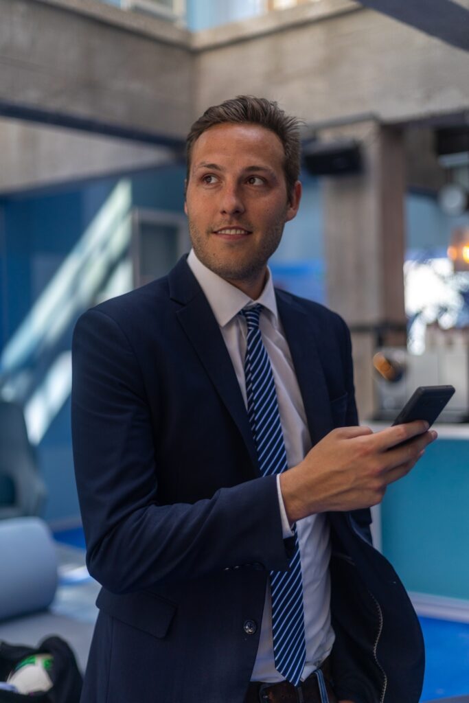 man in suit standing in dating photo