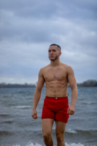 man standing shirtless in a dating photo